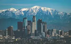 Downtown Los Angeles skyscrapers with the snow-capped San Gabriel Mountains behind